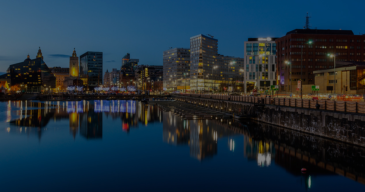 Night time Photo of City Building By The River